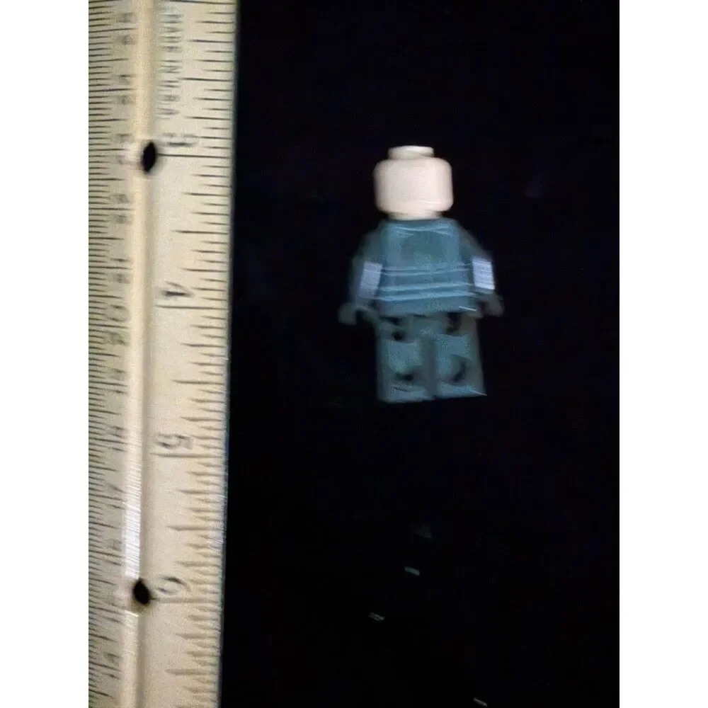 LEGO minifig with black tactical suit and and angry bald head